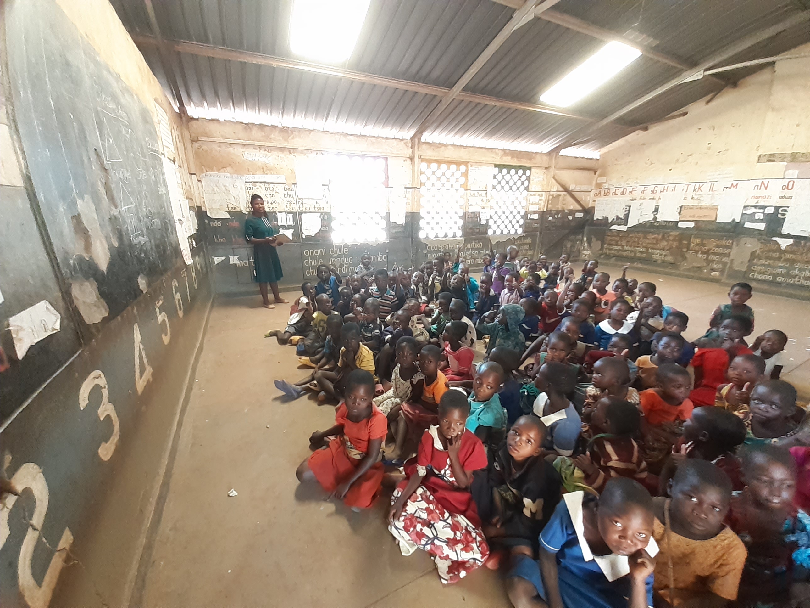 Teacher in classroom with large class of students at Mteza LEA school, Malawi.