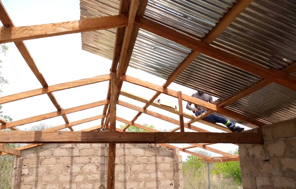 Workman building village school roof at Iddrisu-Krom.