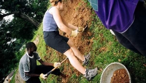 Volunteers digging
                         school foundations in Ghana.