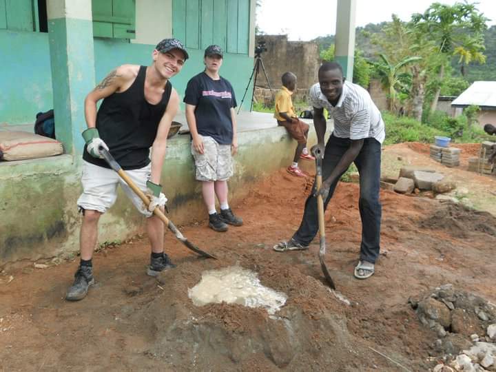 Volunteers making cement for a school building project in Ghana.